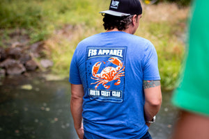 Light blue fis tee shirt with a dunganess crab on the back