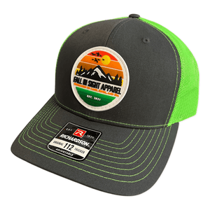 Neon green and gray fis trucker hat with a retro mountain patch on the front